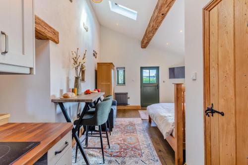 a kitchen and living room with a bed and a table at 1 Bed in Bracewell oc-l33325 in West Marton
