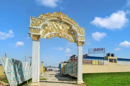 a golden archway in front of a building at Hotel O UDAAN BANQUET & FILMS in Khagaul