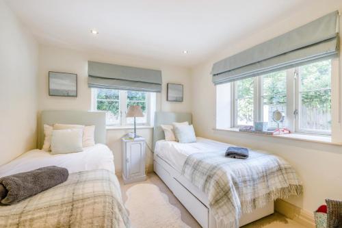 two beds in a room with two windows at 2 Bed in Langham oc-l33117 in Langham