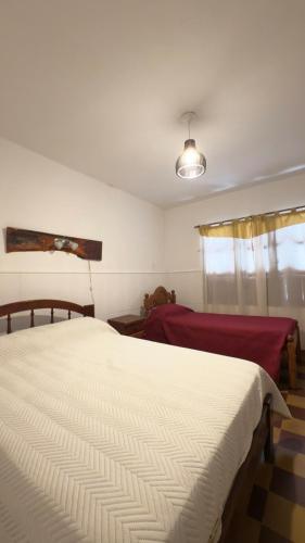 a bedroom with a white bed and a window at Tanti in Reyes