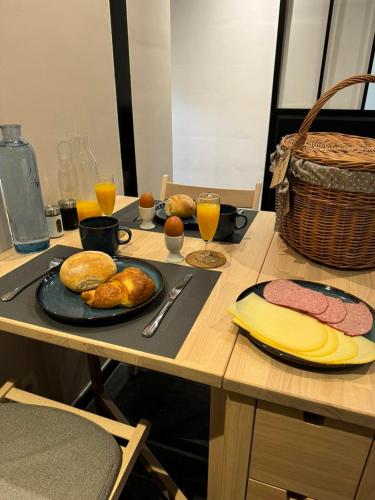 a table with plates of food and drinks on it at La Suite d'Ondine in Lobbes