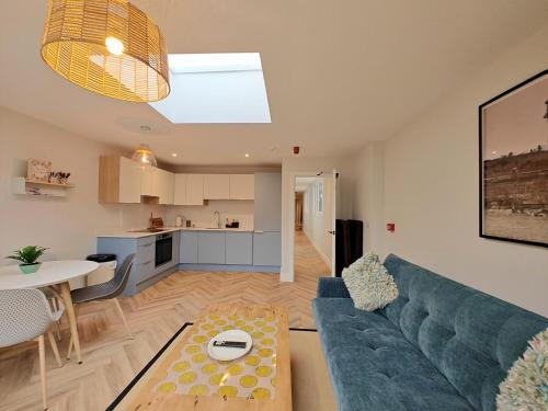 a living room with a blue couch and a kitchen at 3 Bed in Shanklin oc-w33402 in Shanklin
