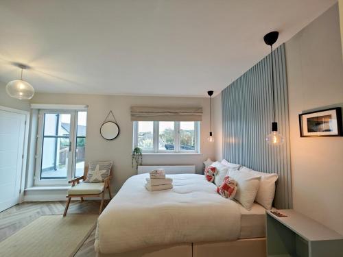 a bedroom with a large white bed and a chair at 3 Bed in Shanklin oc-h33403 in Shanklin