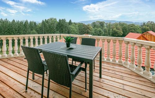 a black table and chairs on a wooden deck at 2 Bedroom Lovely Apartment In Stainz in Stainz
