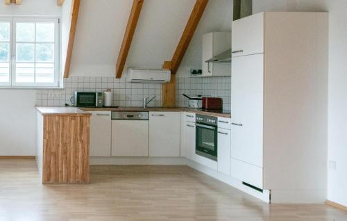 a kitchen with white appliances and a large window at 2 Bedroom Lovely Apartment In Stainz in Stainz