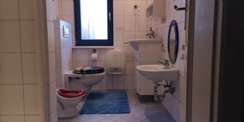 a small bathroom with a toilet and a sink at Märchengarten Hänsel und Gretel in Putbus