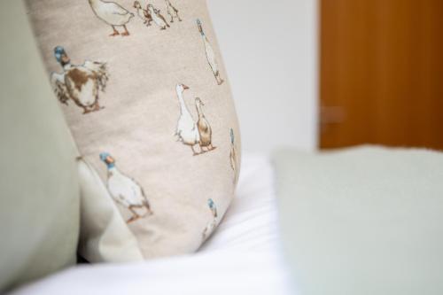 a close up of a pillow with birds on it at St James Court Hotel in Derby