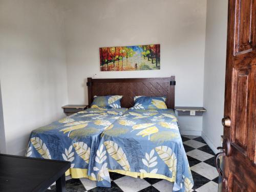 a bedroom with a bed and a painting on the wall at Kaisers Sunset Hotel - Adults Only, Negril in Negril