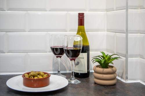 a bottle of wine and two glasses on a table at St James Court Hotel in Derby