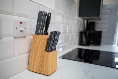 a knife block on a kitchen counter with three knives at St James Court Hotel in Derby