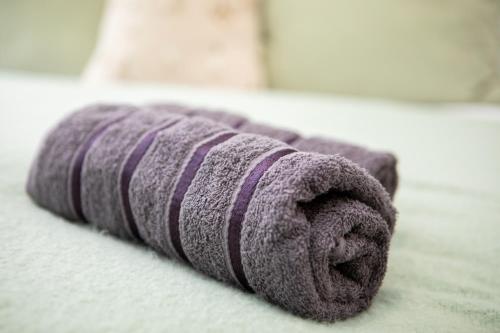 a purple towel laying on top of a bed at St James Court Hotel in Derby