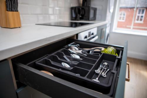 a drawer in a kitchen with a stove with keys in it at St James Court Hotel in Derby