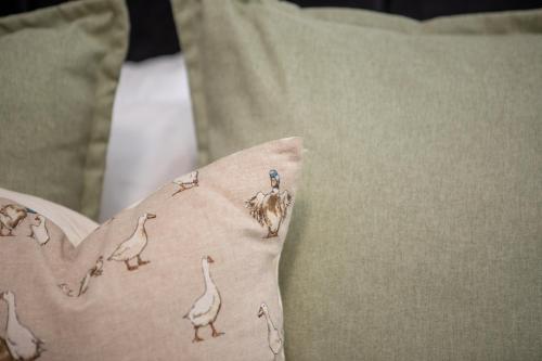 a person holding a pillow with birds on it at St James Court Hotel in Derby