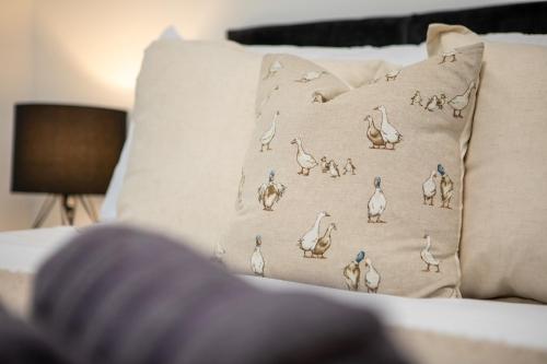 a pillow with birds on it on a couch at St James Court Hotel in Derby