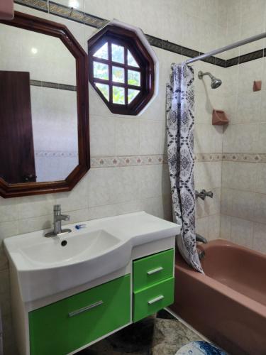 a bathroom with a sink and a bath tub at Kaisers Sunset Hotel - Adults Only, Negril in Negril
