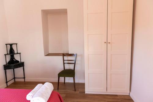 a bedroom with a bed and a chair and a closet at Casa rural DOS ENCINAS in Andújar