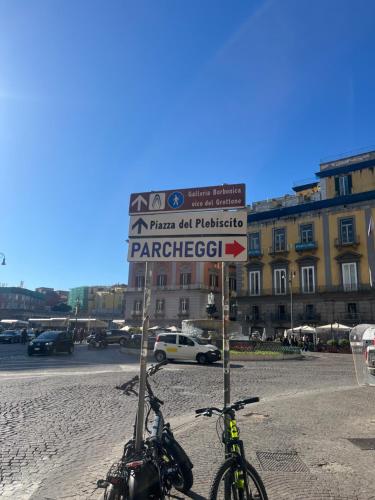 two bikes are parked next to a street sign at Casetta Piazza Plebiscito in Naples