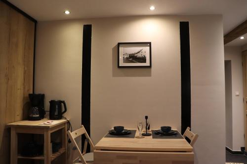 a dining room with two tables and two chairs at La Suite d'Ondine in Lobbes