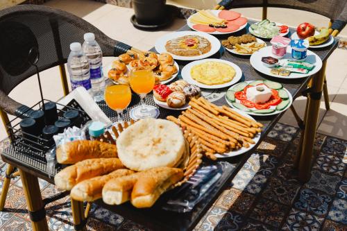a table topped with plates of food and drinks at Five Pyramids Peaks View in Cairo
