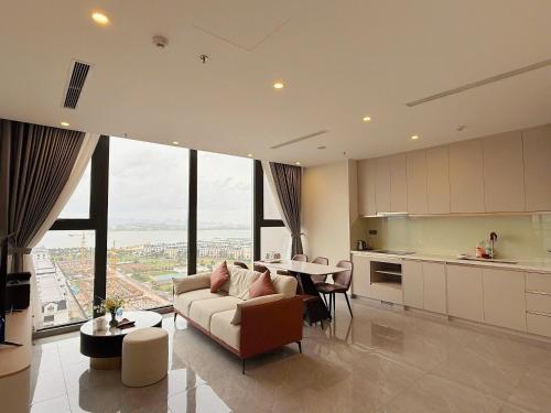 a living room with a couch and a table in a kitchen at ICON40 Ha Long Luxury Apart in Ha Long