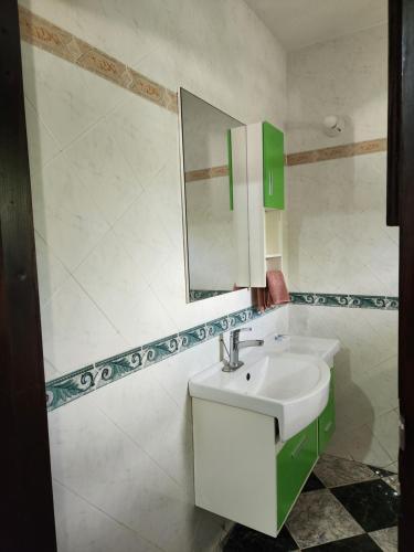 a bathroom with a sink and a mirror at Kaisers Sunset Hotel - Adults Only, Negril in Negril