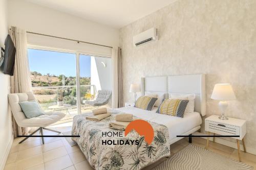 une chambre avec un grand lit et un balcon dans l'établissement #339 Terras Novas N 4 By Home Holidays, à Vale da Ursa