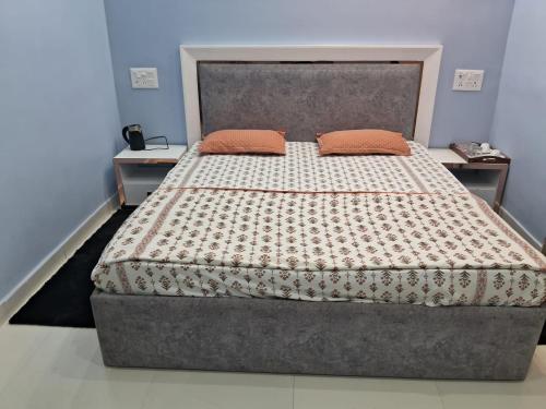 a bed with two pillows on it in a bedroom at Kailash Haveli in Bikaner
