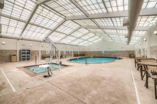 a large indoor pool with a skylight and a swimming pool at Candlewood Suites Tacoma WA by IHG in Tacoma