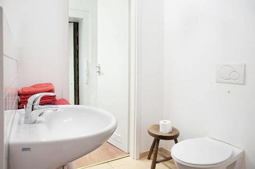a white bathroom with a sink and a toilet at 100 qm großes lichtdurchflutetes Loft im Herzen der City in Bochum