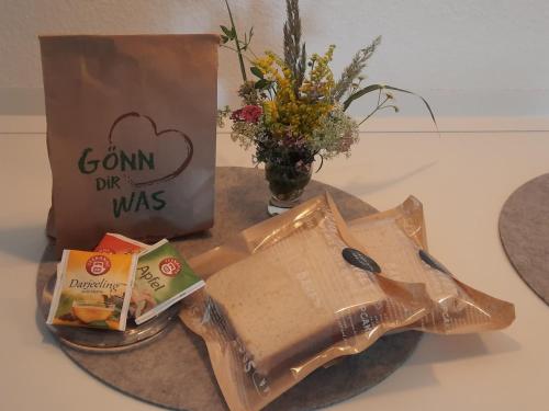 a bag of food and a box of corn dip and flowers at Apartment with terrace in Zeuthen