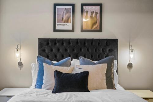 a bedroom with a bed with pillows and posters on the wall at Wakefield Shakespeare - Parking Included in Wakefield