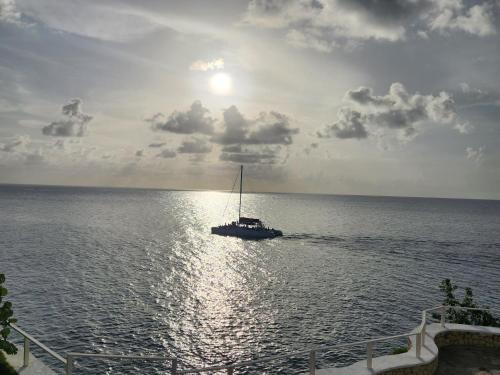 a boat in the middle of the ocean at Kaisers Sunset Hotel - Adults Only, Negril in Negril