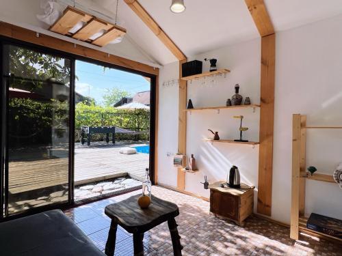 a living room with a couch and a table at Tiny House Nada Vineyard in Rakhat