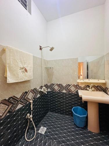 a bathroom with a sink and a shower at Apartment in Karachi near airport in Karachi