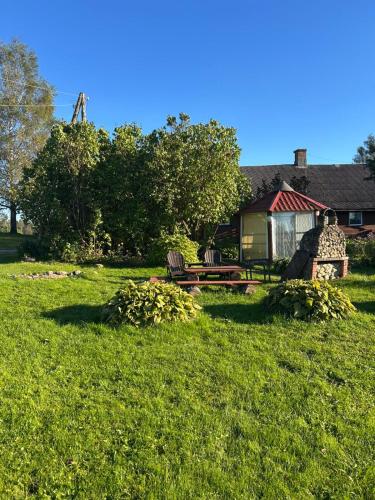 a house with a picnic table in a yard at Pūnas in Cēsis