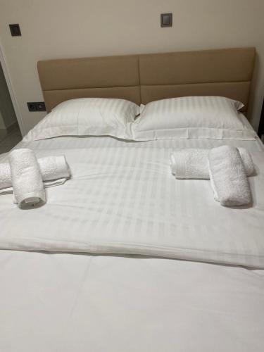 a large white bed with two towels on it at Adorable apartment in Athens