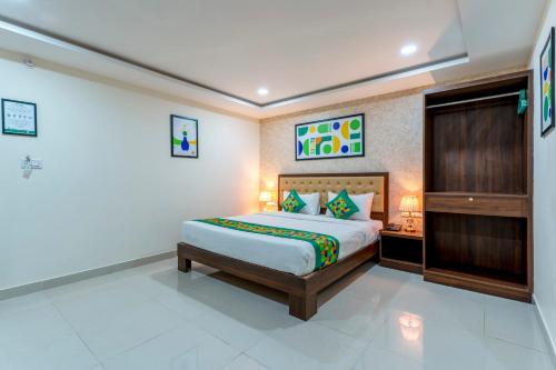 a bedroom with a king sized bed in a room at Treebo Silent Woods in Bengaluru