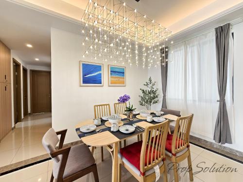 a kitchen and dining room with a table and chairs at Cozy Seaview Suite Johor Bahru CIQ in Johor Bahru