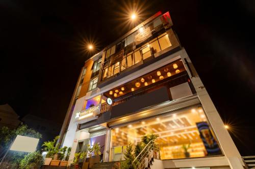 a tall building with lights on it at night at Treebo Silent Woods in Bengaluru