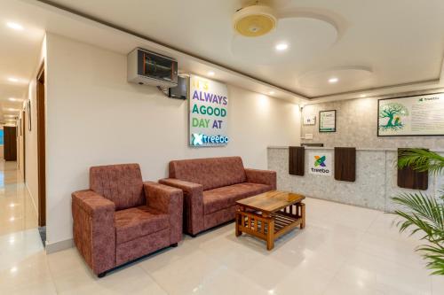 a waiting room with two chairs and a table at Treebo Silent Woods in Bengaluru