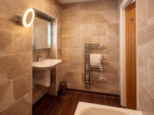 a bathroom with a sink and a toilet and a mirror at The Black Boy Inn in Caernarfon