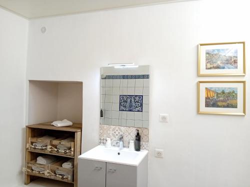 a bathroom with a sink and a mirror at Grand Hôtel de l'Europe - Morlaix Centre in Morlaix
