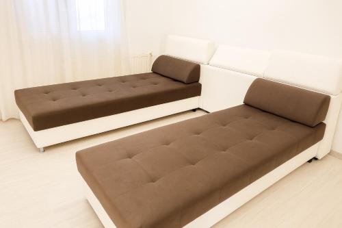 two beds in a living room with a couch at THEODORA SUITE SMART KEY BOX by PROJECT 86 IKE in Agrinion