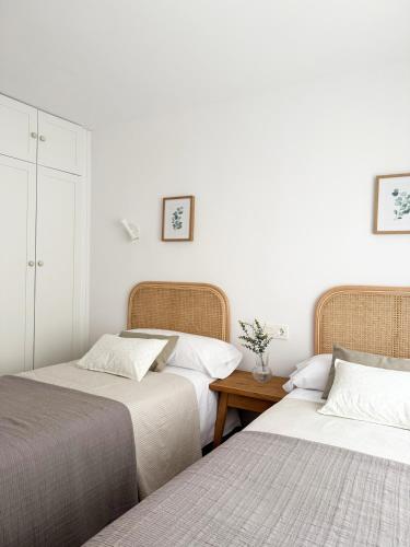 two beds sitting next to each other in a bedroom at Megara Home in Soria