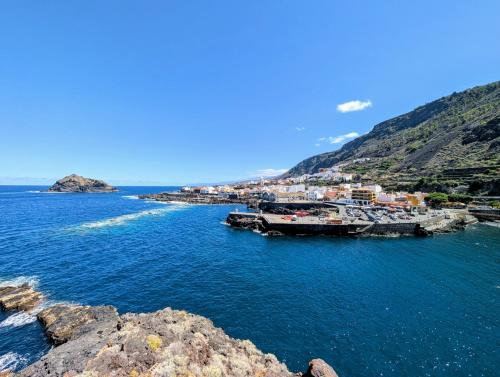 a large body of water with a town on a hill at CHC - Apartamento La Libertad Garachico in Garachico