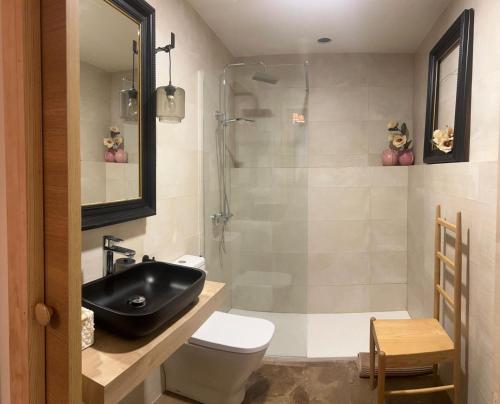 a bathroom with a sink and a toilet and a shower at Casa Rural La Real de Guadalupe in Guadalupe