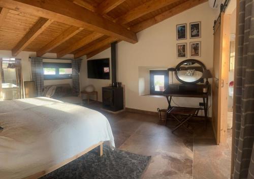 a bedroom with a white bed and a mirror at Casa Rural La Real de Guadalupe in Guadalupe