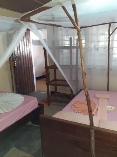a room with two bunk beds and a ladder at NEW ORANGE APARTMEnt in Jambiani
