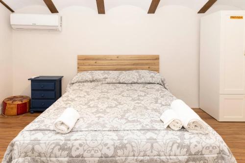 a bedroom with a bed with two towels on it at Casa rural DOS ENCINAS in Andújar