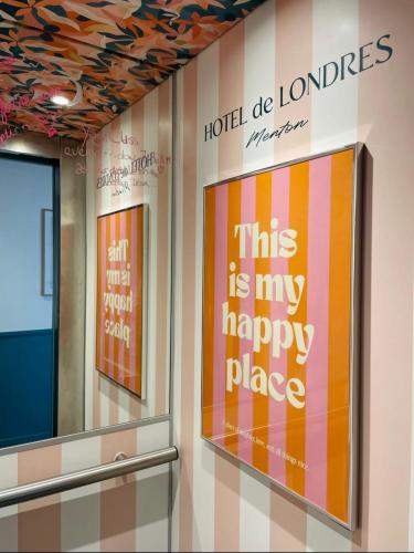 a sign that says this is my happy place on a wall at Hôtel De Londres in Menton
